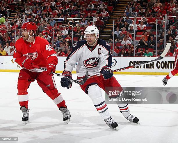 Rick Nash of the Columbus Blue Jackets tries to skate around Henrik Zetterberg of the Detroit Red Wings during an NHL game at Joe Louis Arena on...