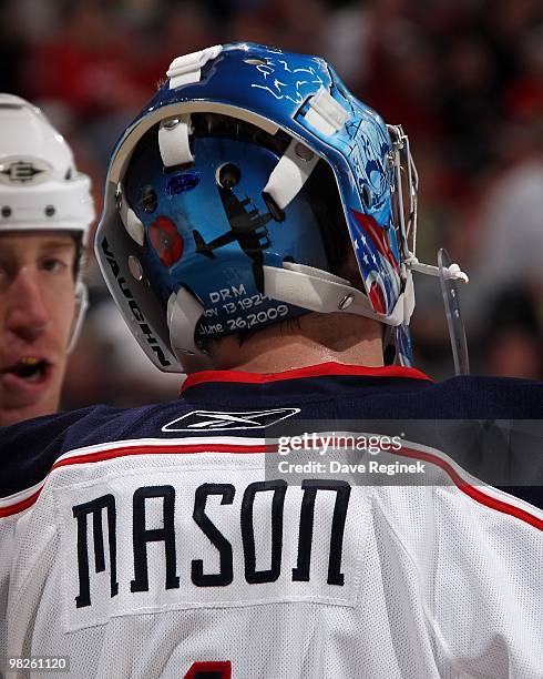 Steve Mason of the Columbus Blue Jackets talks with teammate Mike Commodore during an NHL game against the Detroit Red Wings at Joe Louis Arena on...