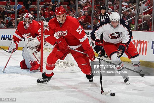 Andrew Murray of the Columbus Blue Jackets battles for the puck with Jonathan Ericsson of the Detroit Red Wings during an NHL game at Joe Louis Arena...