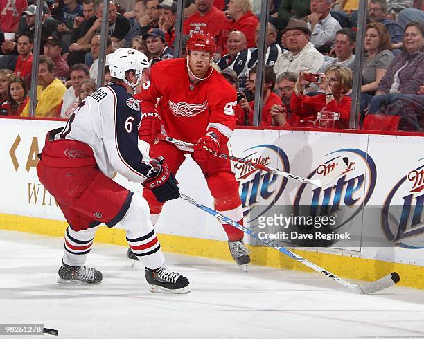 Johan Franzen of the Detroit Red Wings makes a pass past Anton Stralman of the Columbus Blue Jackets during an NHL game at Joe Louis Arena on April...