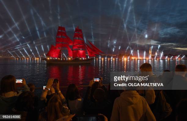 Vintage ship with scarlet sails passes on the Neva River in central Saint Petersburg, late on June 23 during the "Scarlet Sails," a romantic holiday...