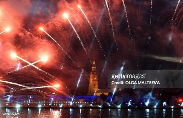 Fireworks explode on the Neva River in central Saint Petersburg, late on June 23 during the "Scarlet Sails," a romantic holiday with laser show to...