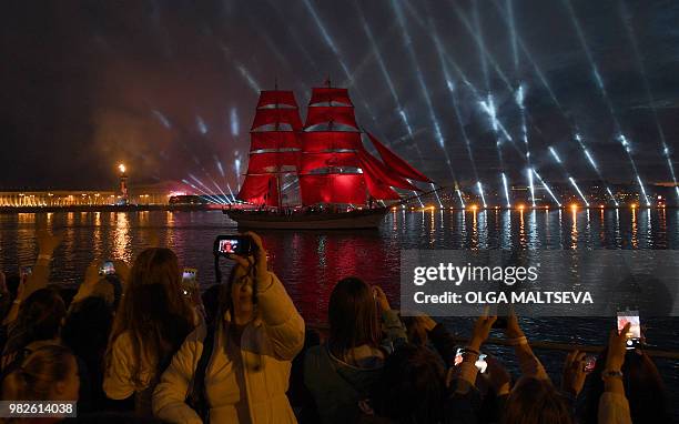 Vintage ship with scarlet sails passes on the Neva River in central Saint Petersburg, late on June 23 during the "Scarlet Sails," a romantic holiday...