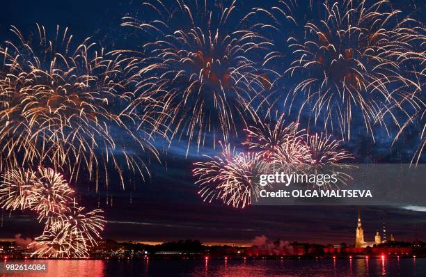 Fireworks explode on the Neva River in central Saint Petersburg, late on June 23 during the "Scarlet Sails," a romantic holiday with laser show to...