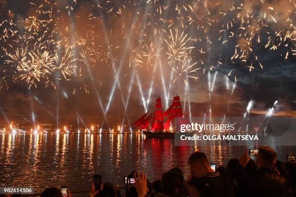 Vintage ship with scarlet sails passes on the Neva River in central Saint Petersburg, late on June 23 during the "Scarlet Sails," a romantic holiday...