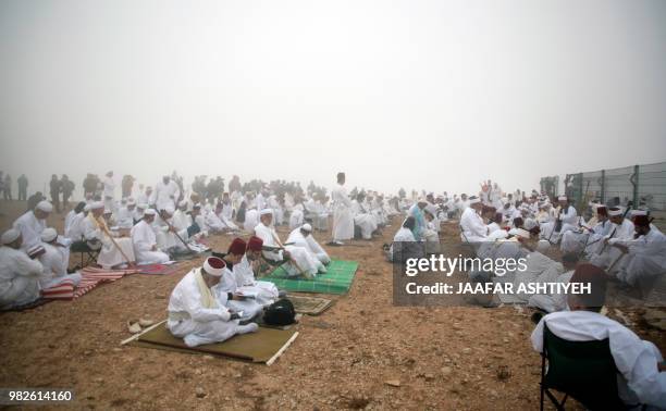 Samaritan worshipers gather at dawn to pray on top of Mount Gerizim near the northern West Bank city of Nablus on June 24, 2018 during celebrations...