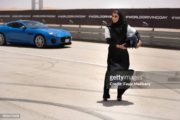 Saudi female racing driver, Aseel Al Hamad celebrates the end of the ban on women drivers, and the launch of World Driving Day with a lap of honour...