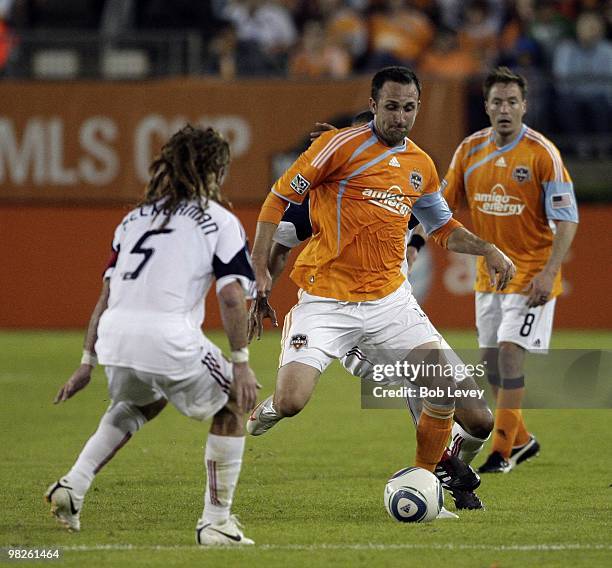 Ryan Cochrane of the Houston Dynamo brings the ball up the field as he is defended by Kyle Beckerman of Real Salt Lake on April 1, 2010 in Houston,...