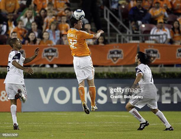 Bobby Boswell of the Houston Dynamo heads the ball the away from Alvaro Saborio, left, and Fabian Espindola of Real Salt Lake at Robertson Stadium on...