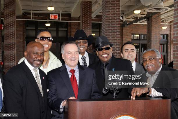 Singer Charlie Wilson poses for photos with ABC Chicago's Ken Bedford; radio personality Ramon Wade; Mayor Richard M. Daley; radio personality Herb...