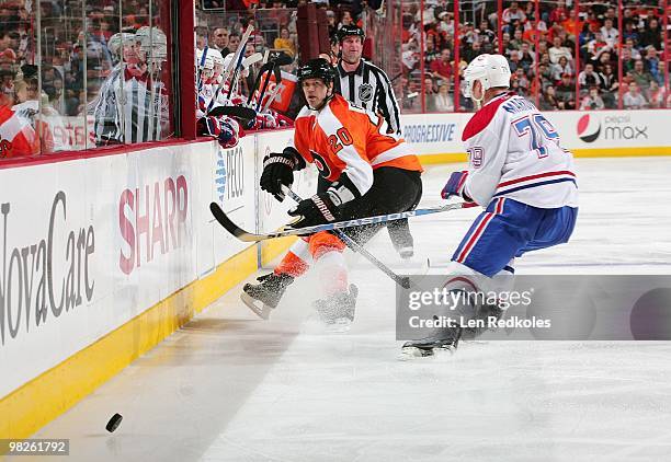 Chris Pronger of the Philadelphia Flyers dumps the puck into the offence zone past Andrei Markov of the Montreal Canadiens on April 2, 2010 at the...