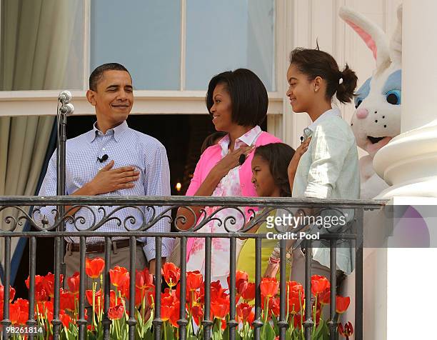 President Barack Obama, First Lady Michelle Obama and their daughters Sasha and Malia listen to the National Anthem during the annual White House...
