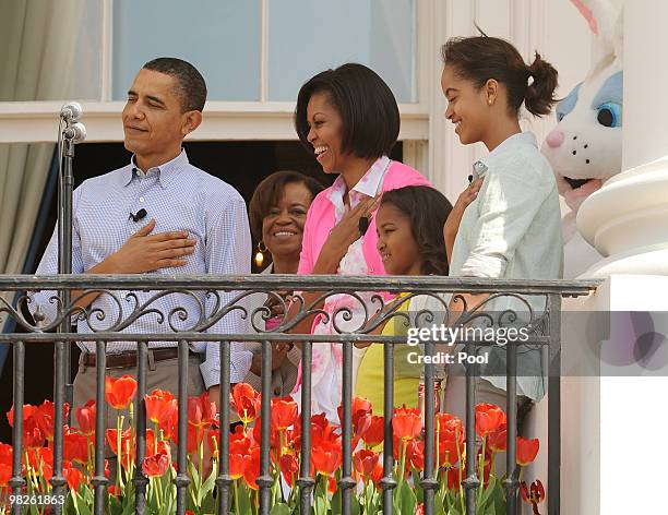 President Barack Obama, Michelle's mother Marian Robinson, First Lady Michelle Obama and their daughters Sasha and Malia listen to the National...