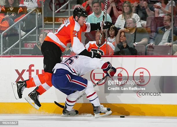 Andrei Kostitsyn of the Montreal Canadiens hip checks James van Riemsdyk of the Philadelphia Flyers off the puck on April 2, 2010 at the Wachovia...