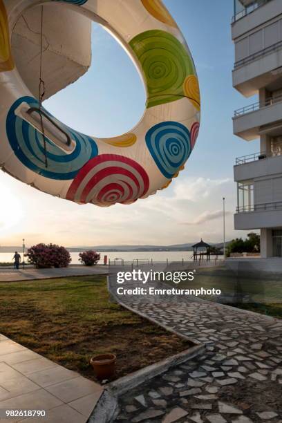 inflatable ring near seaside on a sunny day in cesme. - emreturanphoto stock pictures, royalty-free photos & images