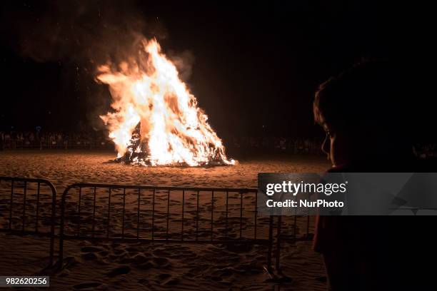 Child observes the municipal bonfire that they light on the beach of Santander during the night of San Juan, Spain, on June 23, 2018. The Night of...