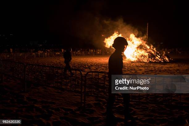 The firefighters watch the municipal burner that lights on the Santander Beach during the Night of San Juan, Spain, on June 23, 2018. The Night of...