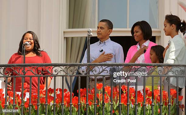 President Barack Obama, First Lady Michelle Obama and their daughters Sasha and Malia listen to TV show Glee's Amber Riley sing the national anthem...