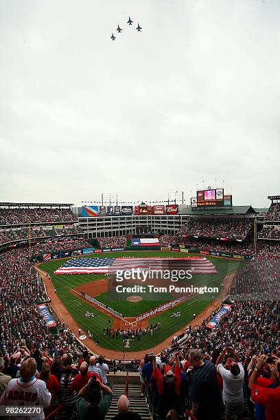 Formation of F-16 fighter jets fly overhead during the National Anthem prior to the Texas Rangers taking on the Toronto Blue Jays on Opening Day at...