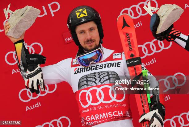 Marcel Hirscher from Austria cheers during the award ceremony of the giant slalom competition at the FIS Alpine Ski World Cup in...