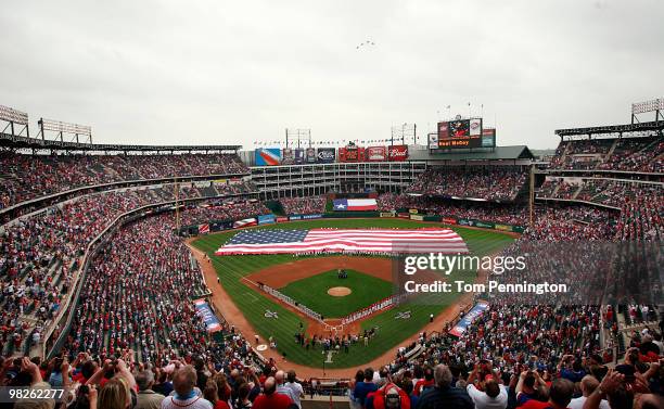 Formation of F-16 fighter jets fly overhead during the national anthem prior to the Texas Rangers taking on the Toronto Blue Jays on Opening Day at...