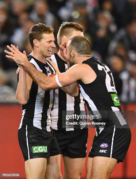 Will Hoskin-Elliott of the Magpies is congratulated by Steele Sidebottom after kicking a goal during the round 14 AFL match between the Collingwood...