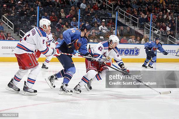 Artem Anisimov and Dan Girardi of the New York Rangers defend against Nik Antropov of the Atlanta Thrashers at Philips Arena on March 12, 2010 in...