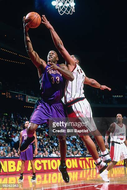 Antonio Davis of the Toronto Raptors shoots against the Houston Rockets during a game played in 2001 at the Compaq Center in Houston, Texas. NOTE TO...