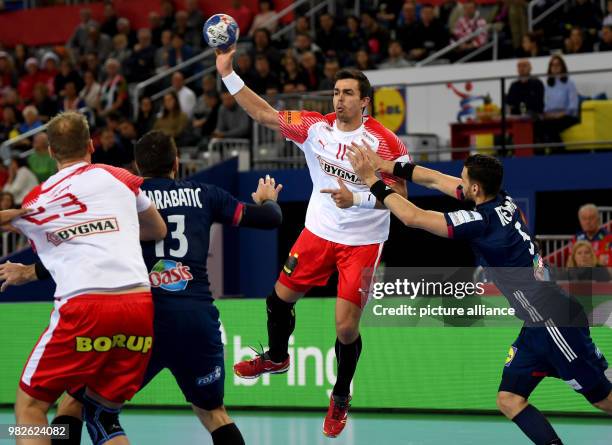 Denemark's Rasmus Lauge Schmidt in action with France's Nedim Remili and Nikola Karabatic during the European Championship handball match for 3rd...