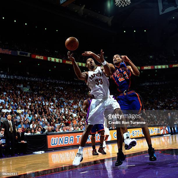 Antonio Davis of the Toronto Raptors battles for the loose ball against the New York Knicks during a game played in 2001 at Air Canada Centre in...