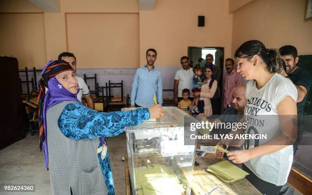 Woman casts her vote at a polling station in snap twin Turkish presidential and parliamentary elections in the Kurdish stronghold of Diyarbakir in...