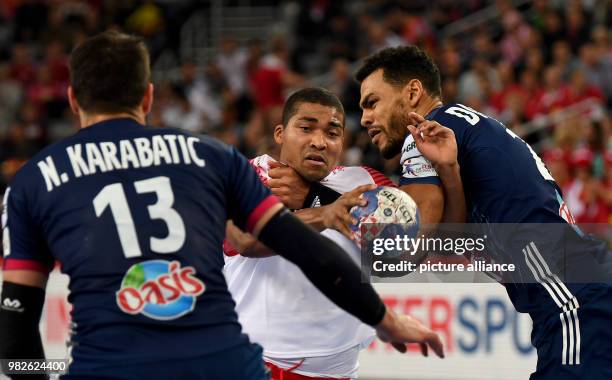 Denemark's Mads Mensah Larsen in action with France's Nikola Karabatic and Adrien Dipanda during the European Championship handball match for 3rd...