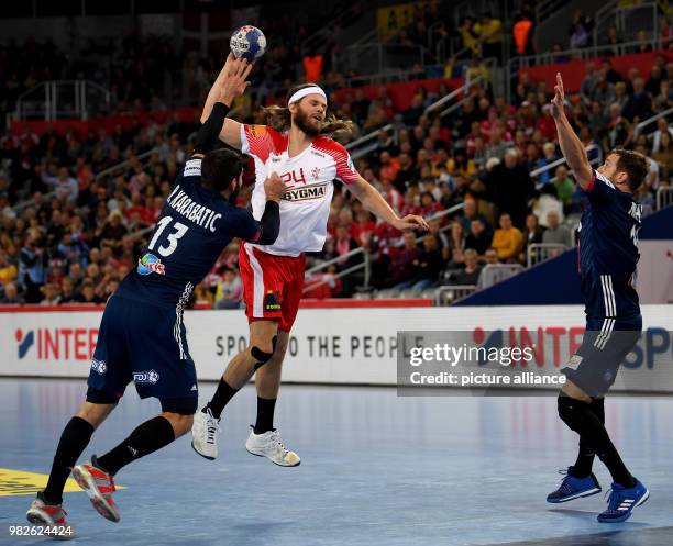 Denemark's Mikkel Hansen in action with France's Nikola Karabatic and Kentin Mahe during the European Championship handball match for 3rd place,...