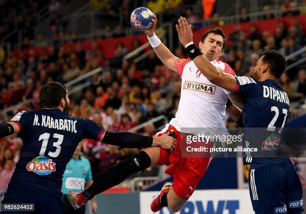 Denemark's Rasmus Lauge Schmidt in action with France's Nikola Karabatic and Adrien Dipanda during the European Championship handball match for 3rd...