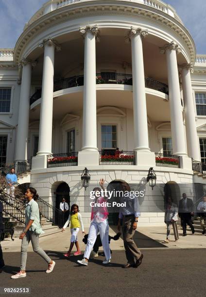 President Barack Obama walks with first lady Michelle Obama, their daughters Malia , Sasha and dog Bo during the annual White House Easter Egg Roll...