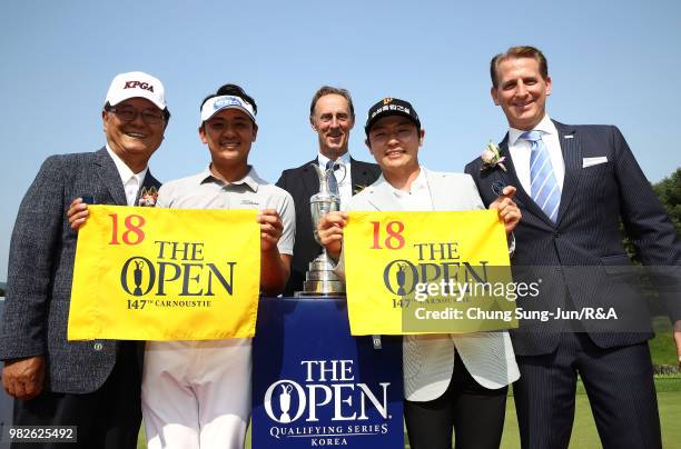 Park Sang-Hyun of South Korea and Choi Min-Chul of South Korea show off The Open 18th Pin Flag after they qualified with a member of The R&A...