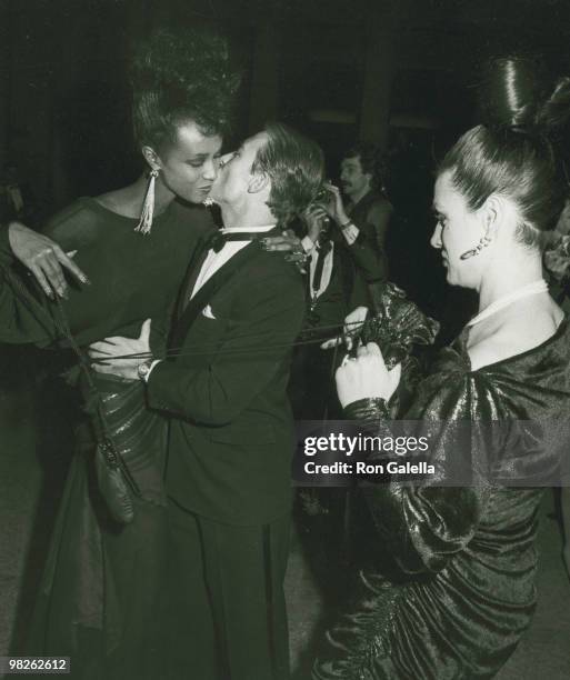 Model Iman and designers Raphael Lopez Sanchez and Paloma Picasso attend the Yves St. Laurent Retrospective Dinner Dance on December 5, 1983 at the...