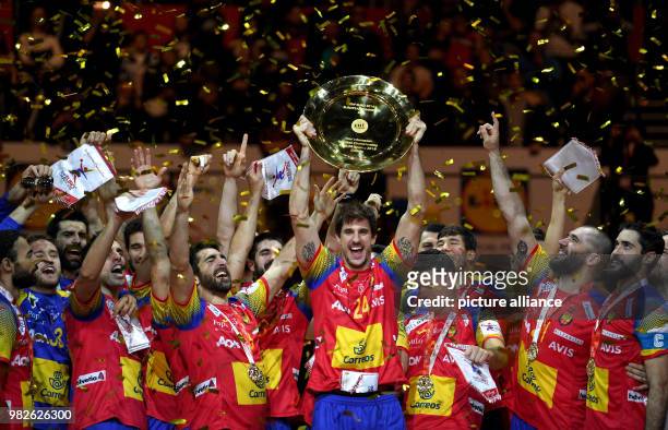 Spain's Viran Morros de Argila cheers with the trophy while his teammates join in during the award ceremony after the finale at the Handball European...