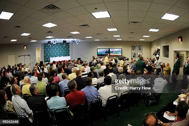 Tiger Woods shakes hands with members of Augusta National Golf Club as he walks into a press conference to address members of the media prior to the...