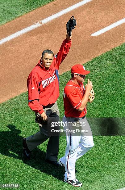 President Barack Obama walks off the field with Ryan Zimmerman after throwing out the opening pitch before the game between the Philadelphia Phillies...