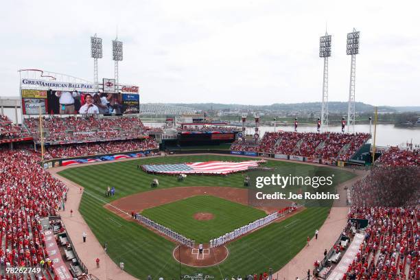 The St. Louis Cardinals and Cincinnati Reds line up for the national anthem sung by former Cincinnati Bengals tight end Ben Utecht at the Great...