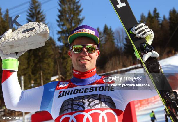 Winner Beat Feuz of Switzerland celebrates at the victory ceremony for the men's downhill event at the Ski World Cup in Garmisch-Partenkirchen,...