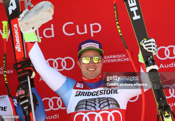 Winner Beat Feuz of Switzerland celebrates at the victory ceremony for the men's downhill event at the Ski World Cup in Garmisch-Partenkirchen,...