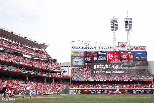 Aaron Harang of the Cincinnati Reds delivers the first pitch of the game to Skip Schumaker of the St. Louis Cardinals at the Great American Ball Park...