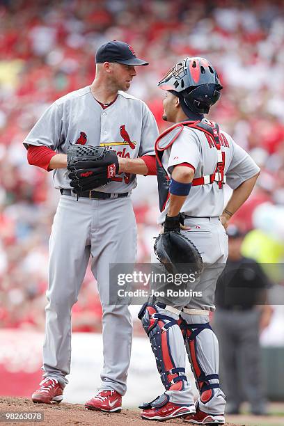 Chris Carpenter and Yadier Molina of the St. Louis Cardinals talk at the mound during the game against the Cincinnati Reds at the Great American Ball...