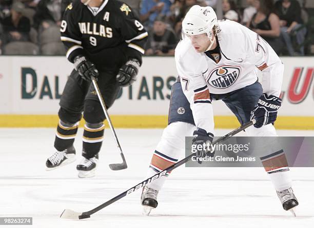 Tom Gilbert of the Edmonton Oilers handles the puck against the Dallas Stars on April 2, 2010 at the American Airlines Center in Dallas, Texas.