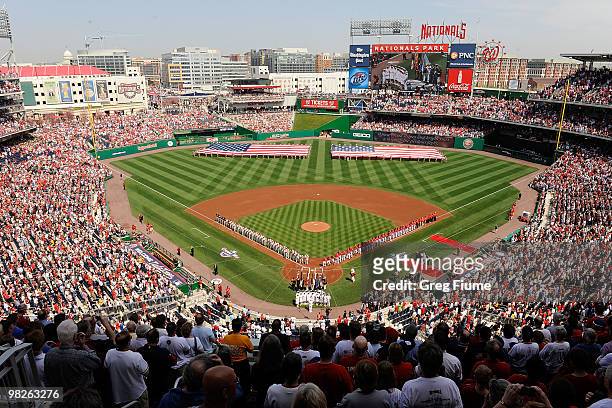 The Philadelphia Phillies and the Washington Nationals line up for the national anthem on Opening Day at Nationals Park on April 5, 2010 in...