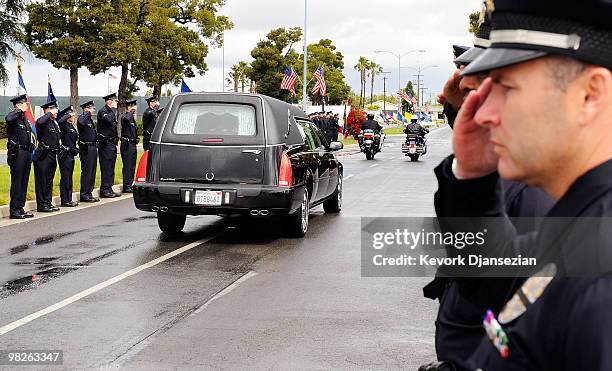 Hearse carrying the remains of LAPD SWAT officer and U.S. Marine reservist Sgt. Maj. Robert J. Cottle passes in between a row of Los Angeles Police...