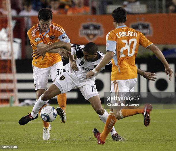 Alvaro Saborio of Real Salt Lake moves the ball between Bobby Boswell and Geoff Cameron of the Houston Dynamo on April 1, 2010 in Houston, Texas.