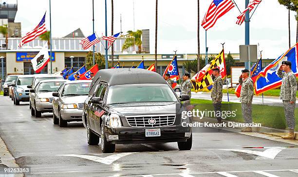 Hearse carrying the remains of LAPD SWAT officer and U.S. Marine reservist Sgt. Maj. Robert J. Cottle passes in front of members of California...